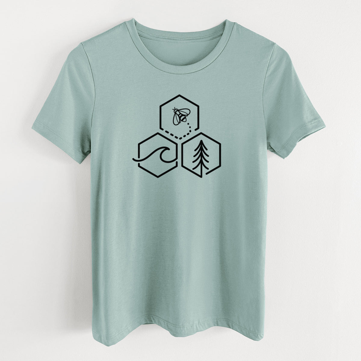 Dusty blue women's relaxed fit cotton t-shirt laid flat, printed with a black line art design of three hexagons holding a bee, an ocean wave and a pine tree.