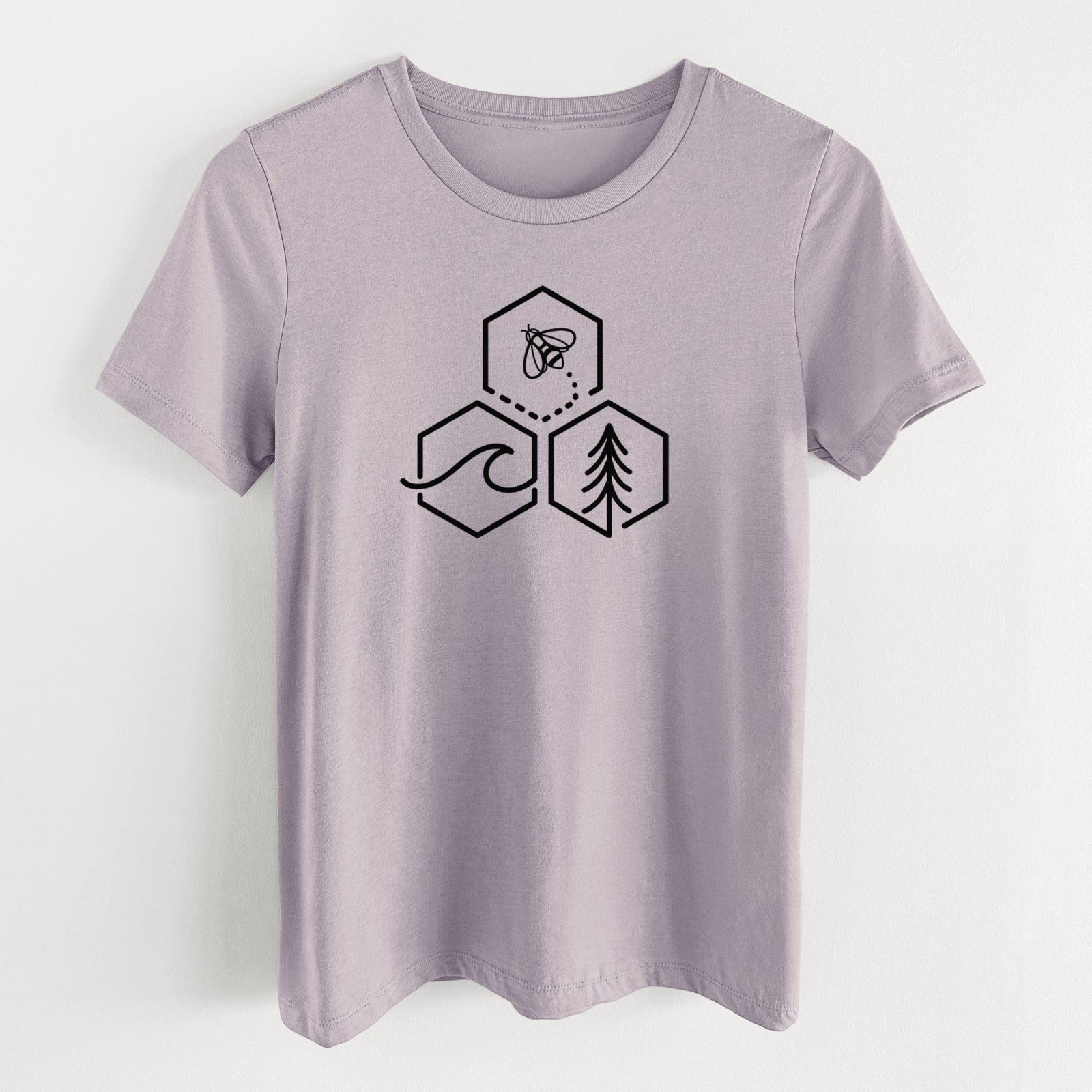 Light violet women's relaxed fit cotton t-shirt laid flat, printed with a black line art design of three hexagons holding a bee, an ocean wave and a pine tree.