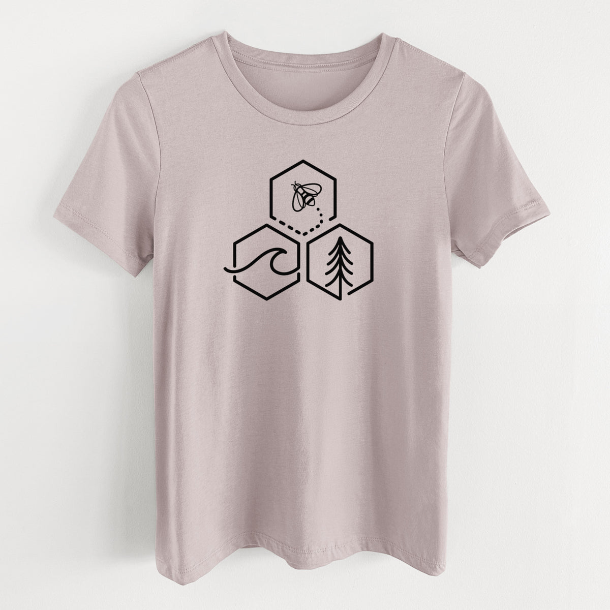 Pink gravel women's relaxed fit cotton t-shirt laid flat, printed with a black line art design of three hexagons holding a bee, an ocean wave and a pine tree.