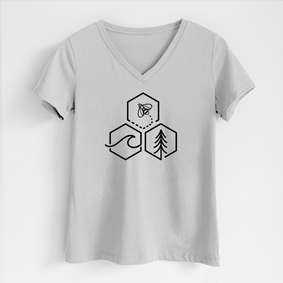 Lunar grey women's relaxed fit cotton V-neck t-shirt laid flat, printed with a black line art design of three hexagons holding a bee, an ocean wave and a pine tree.