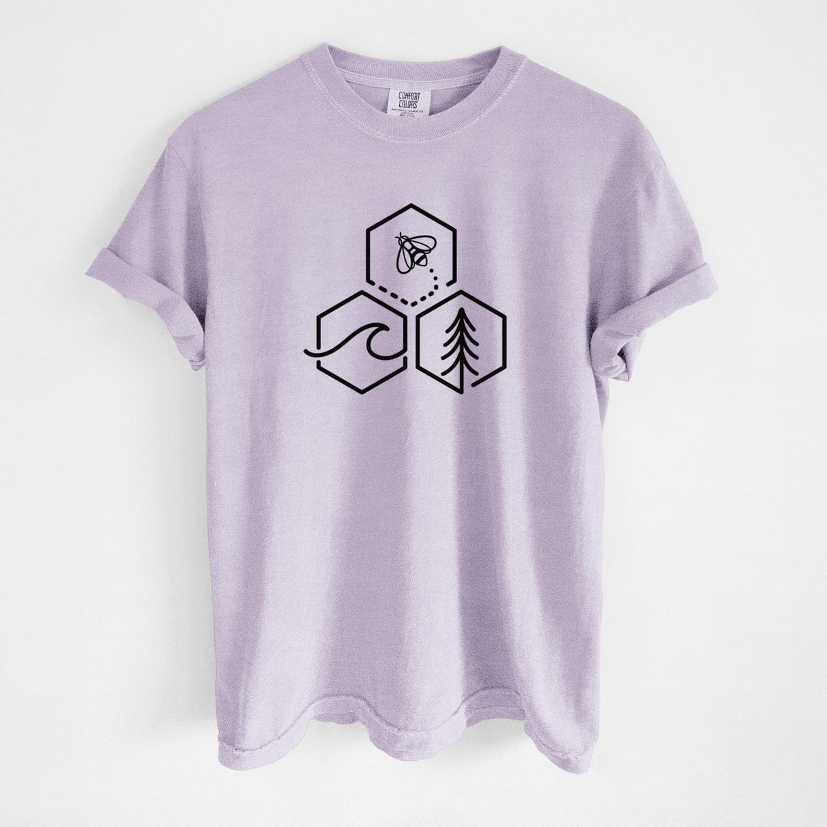 Orchid purple Comfort Colors t-shirt laid flat, printed with a black line art design of three hexagons holding a bee, an ocean wave and a pine tree.