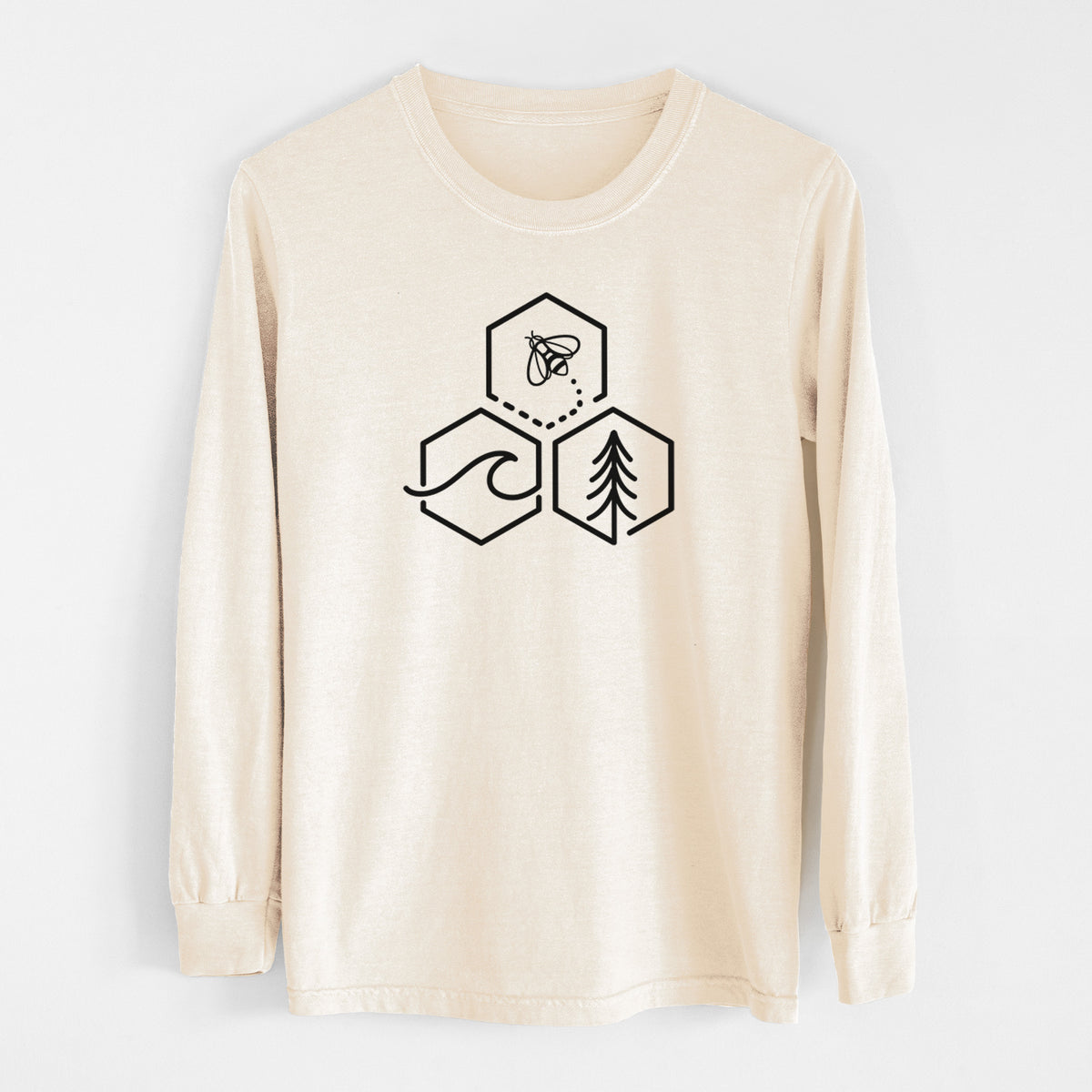 Ivory Comfort Colors long sleeve shirt laid flat, printed with a black line art design of three hexagons holding a bee, an ocean wave and a pine tree.