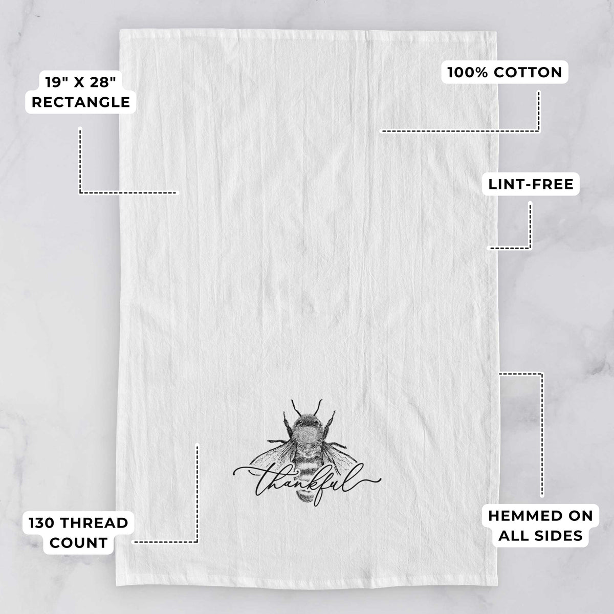 White tea towel printed with a black ink bee with the word thankful written in script across it, with feature labels: 19 by 28 inch rectangle, 100% cotton, lint-free, 130 thread count, hemmed on all sides.