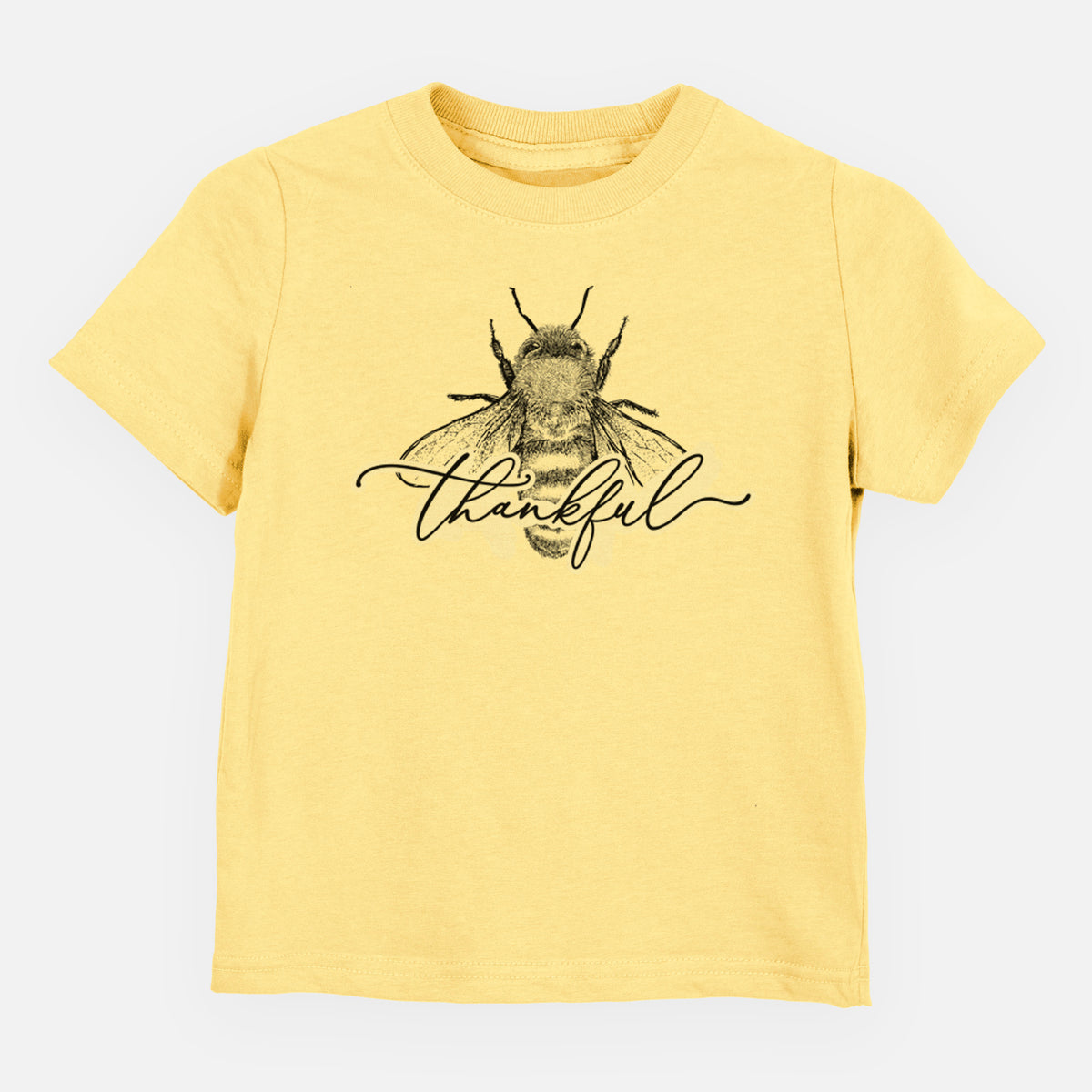 Butter yellow toddler t-shirt laid flat, printed with a black ink bee with the word thankful written in script across it.