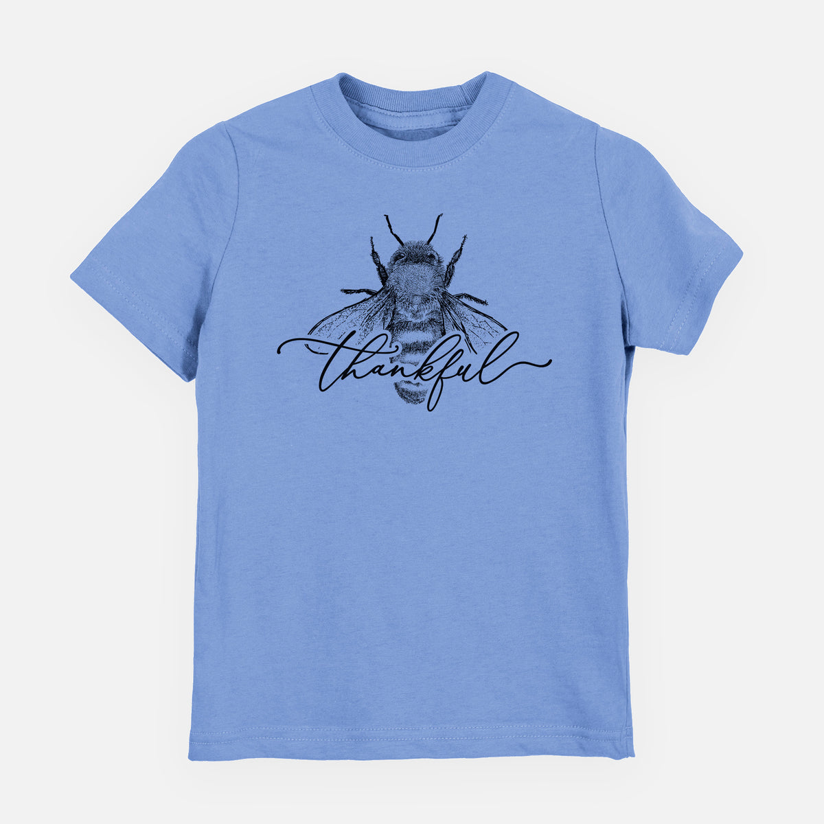 Carolina blue youth t-shirt laid flat, printed with a black ink bee with the word thankful written in script across it.