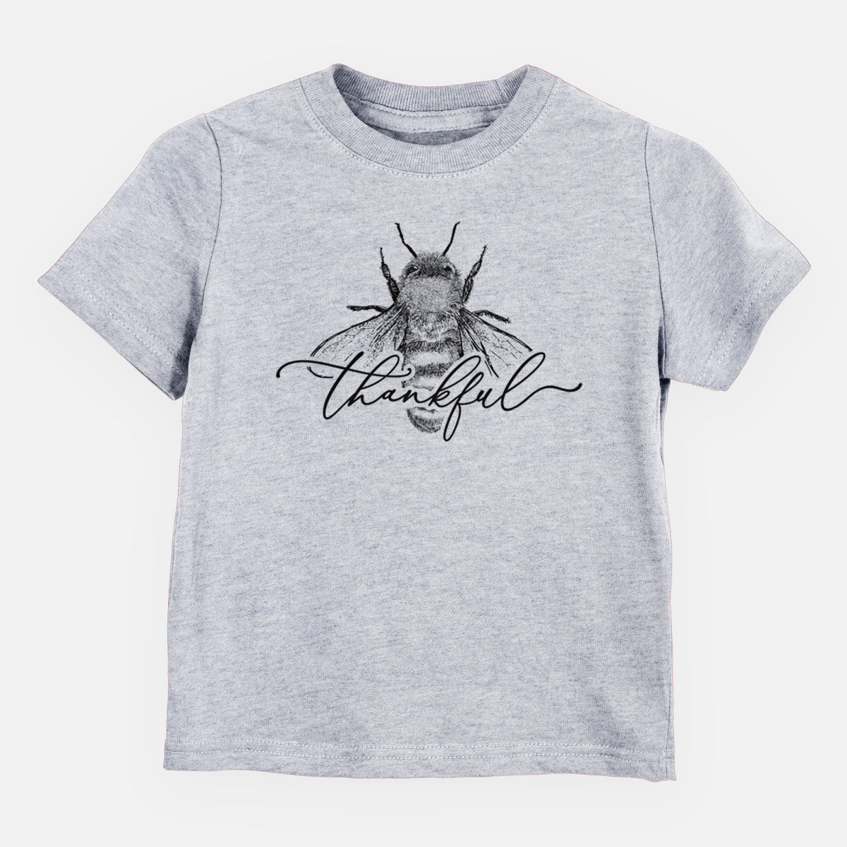Heather grey toddler t-shirt laid flat, printed with a black ink bee with the word thankful written in script across it.