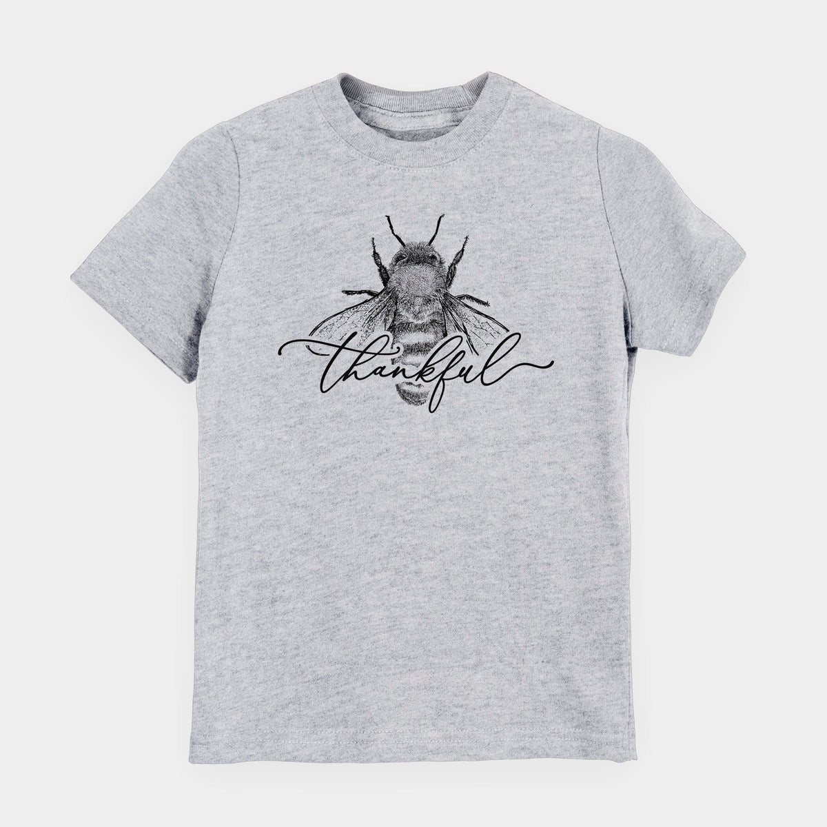 Heather grey youth t-shirt laid flat, printed with a black ink bee with the word thankful written in script across it.