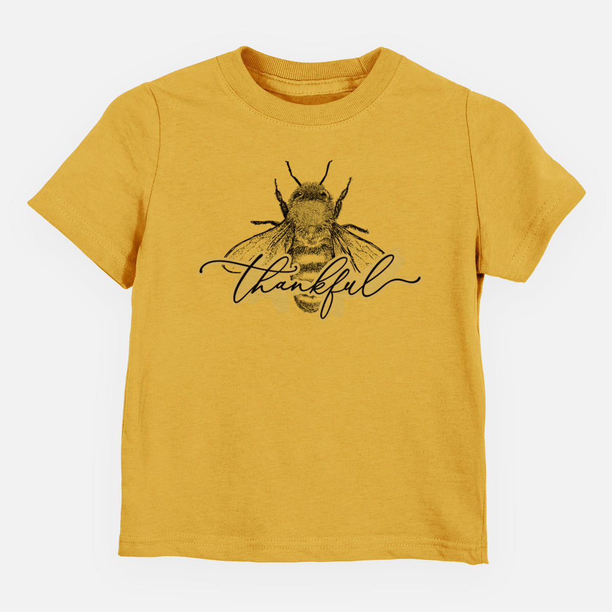 Honeycomb yellow toddler t-shirt laid flat, printed with a black ink bee with the word thankful written in script across it.