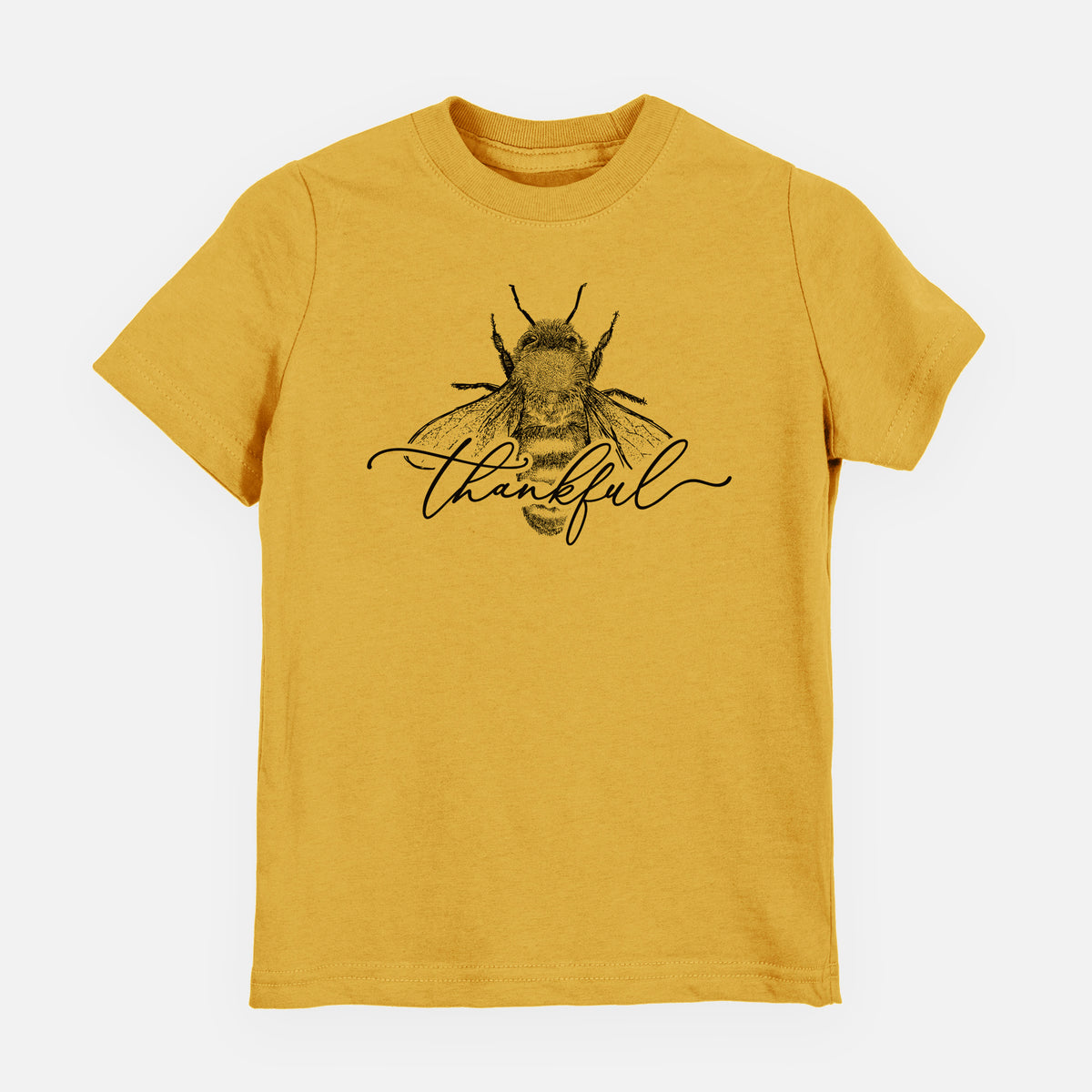 Honeycomb yellow youth t-shirt laid flat, printed with a black ink bee with the word thankful written in script across it.