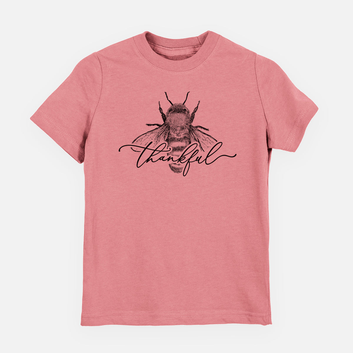 Mauve pink youth t-shirt laid flat, printed with a black ink bee with the word thankful written in script across it.