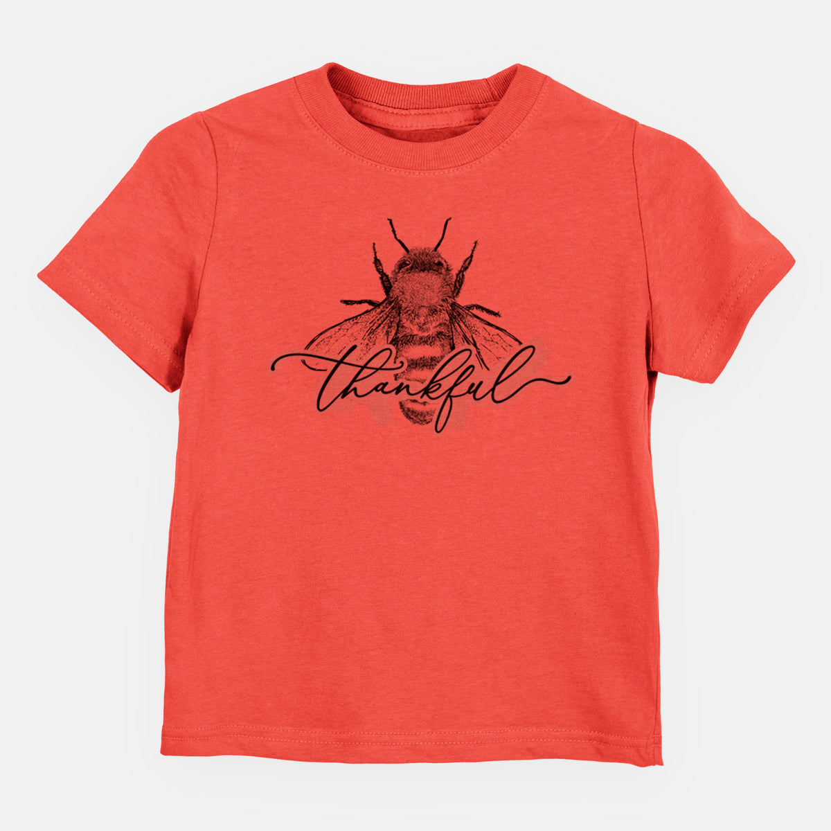 Passionfruit pink toddler t-shirt laid flat, printed with a black ink bee with the word thankful written in script across it.