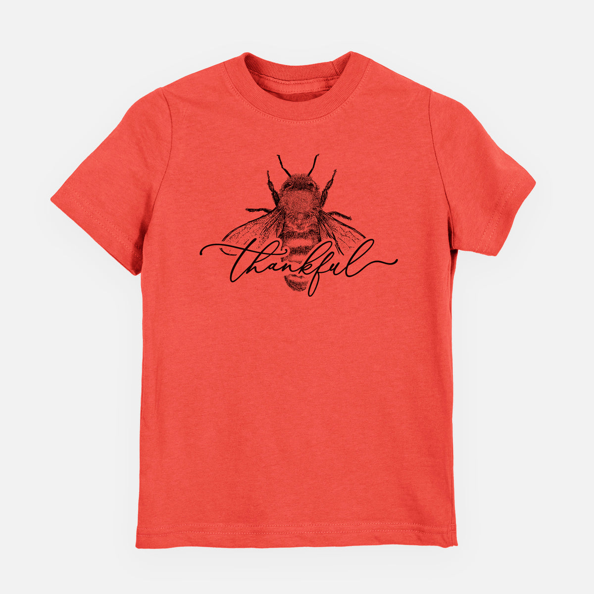 Passionfruit pink youth t-shirt laid flat, printed with a black ink bee with the word thankful written in script across it.