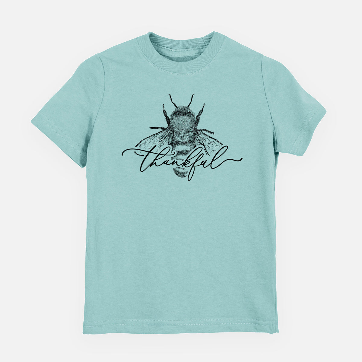 Saltwater youth t-shirt laid flat, printed with a black ink bee with the word thankful written in script across it.