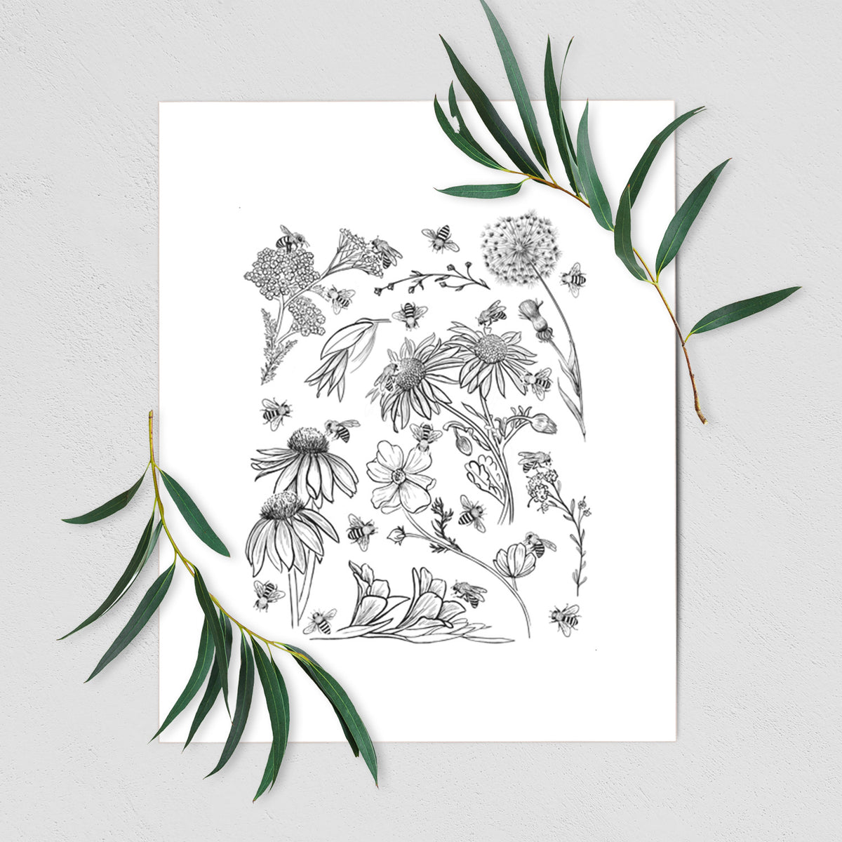 Art print of black ink bees scattered among wildflowers, shown with eucalyptus leaves.