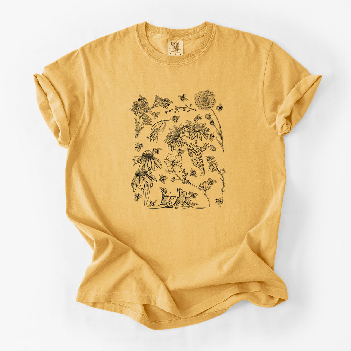 Golden wheat yellow Comfort Colors t-shirt laid flat, printed with black ink bees scattered among wildflowers.
