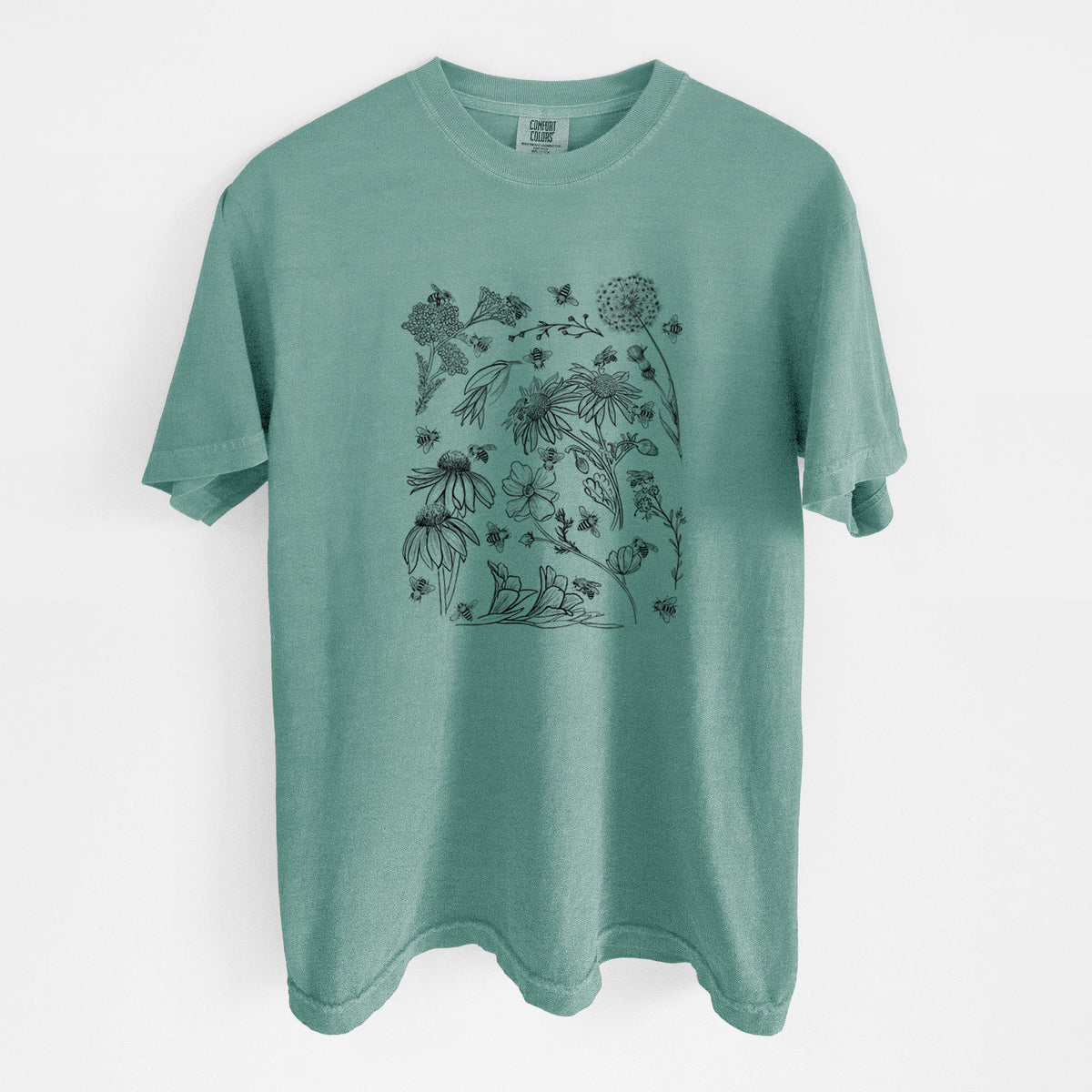 Reef green Comfort Colors t-shirt laid flat, printed with black ink bees scattered among wildflowers.