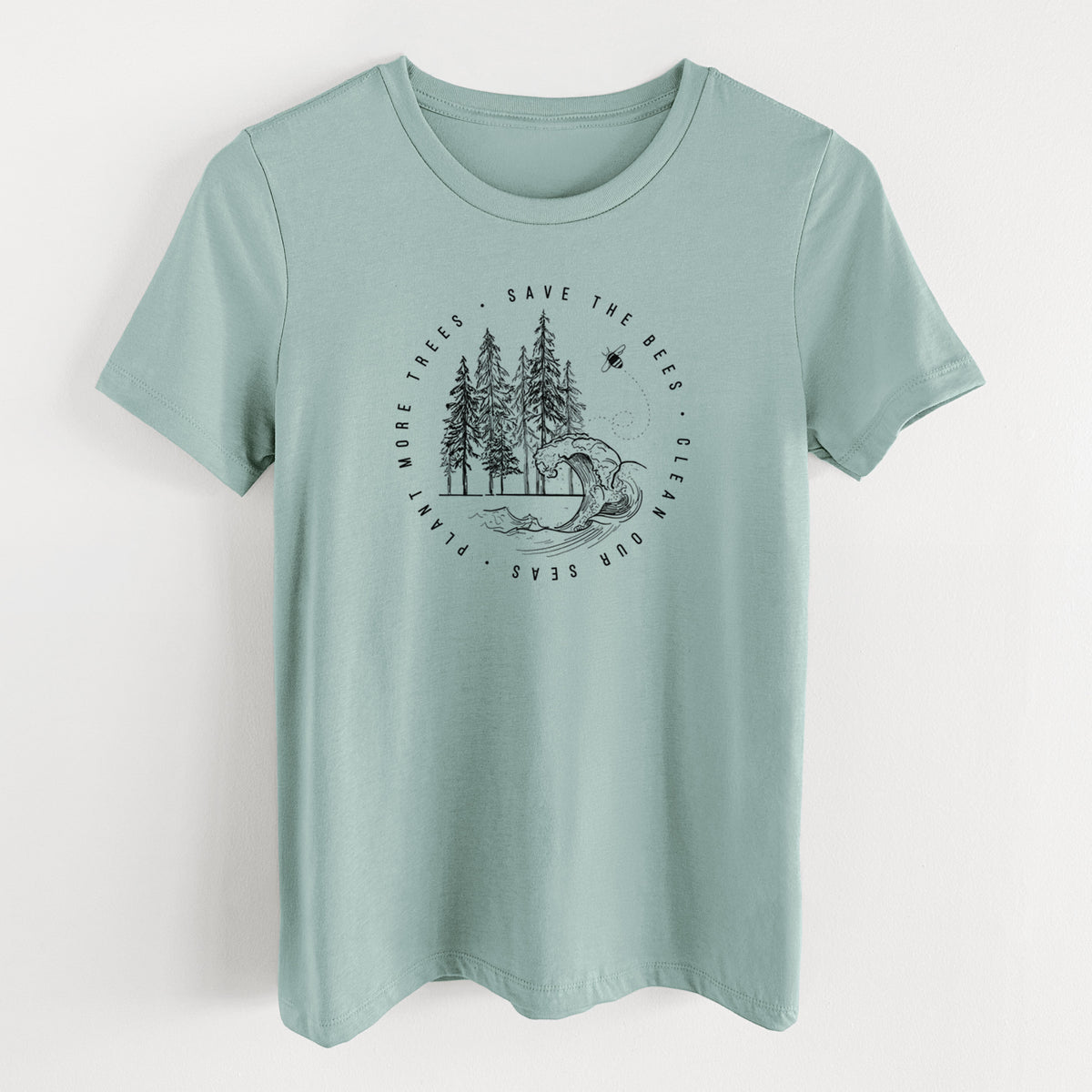 Dusty blue women's relaxed fit cotton t-shirt laid flat, printed with a circle of pine trees and an ocean wave ringed by the words Save the Bees, Clean Our Seas, Plant More Trees.