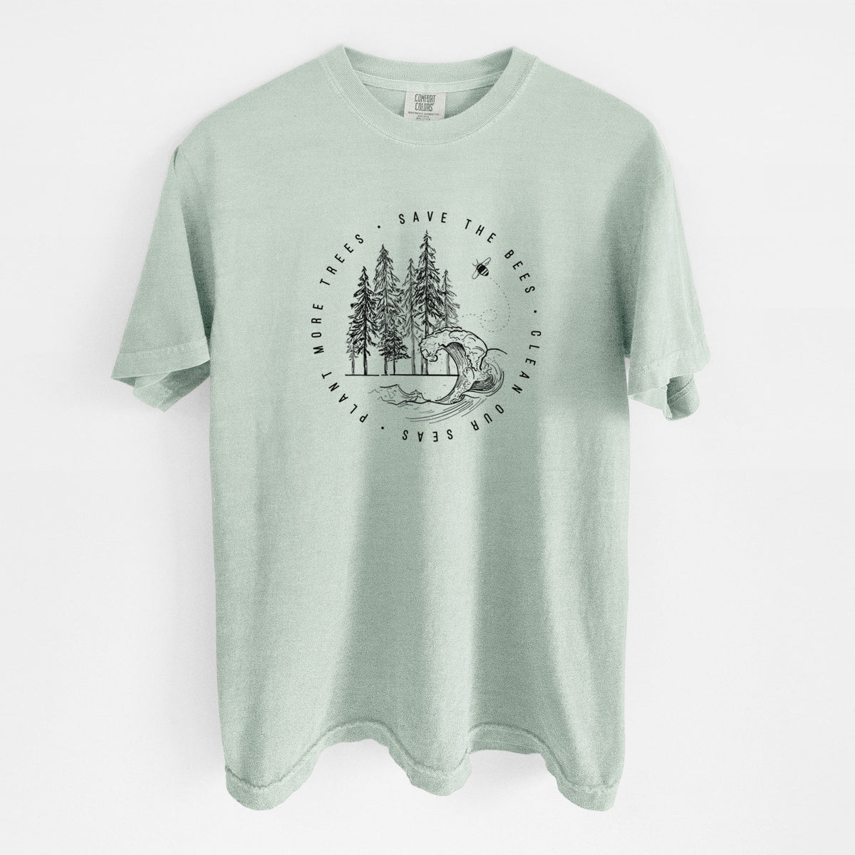 Bay green Comfort Colors t-shirt laid flat, printed with a circle of pine trees and an ocean wave ringed by the words Save the Bees, Clean Our Seas, Plant More Trees.