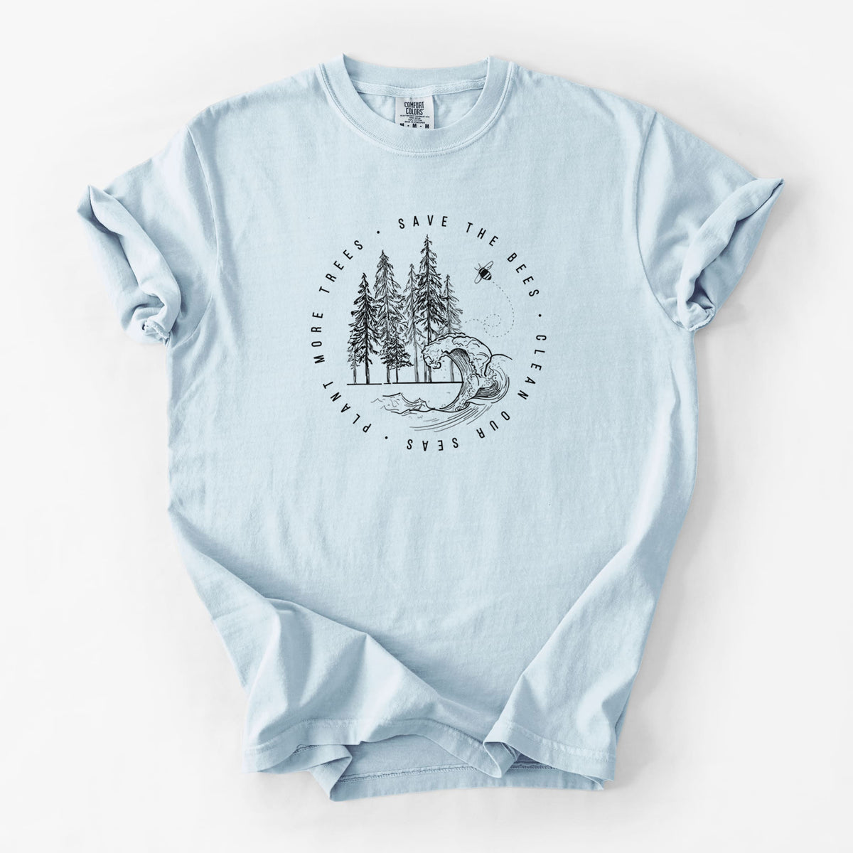Chambray blue Comfort Colors t-shirt laid flat, printed with a circle of pine trees and an ocean wave ringed by the words Save the Bees, Clean Our Seas, Plant More Trees.