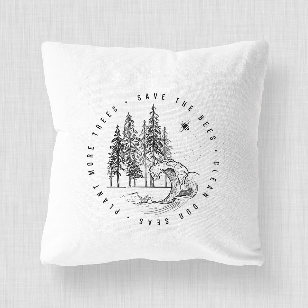 White pillow cover printed with a circle of pine trees and an ocean wave ringed by the words Save the Bees, Clean Our Seas, Plant More Trees.