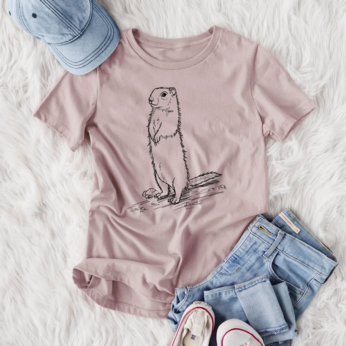 Women's relaxed fit cotton t-shirt printed with a detailed black ink illustration of a Belding's ground squirrel standing upright, styled flat on a white faux fur rug with jeans.