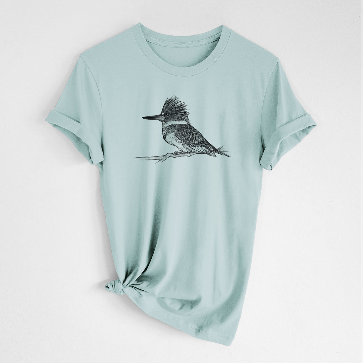 Dusty blue lightweight cotton t-shirt laid flat with the sleeves rolled, printed with a detailed black ink sketch of a belted kingfisher perched on a branch.