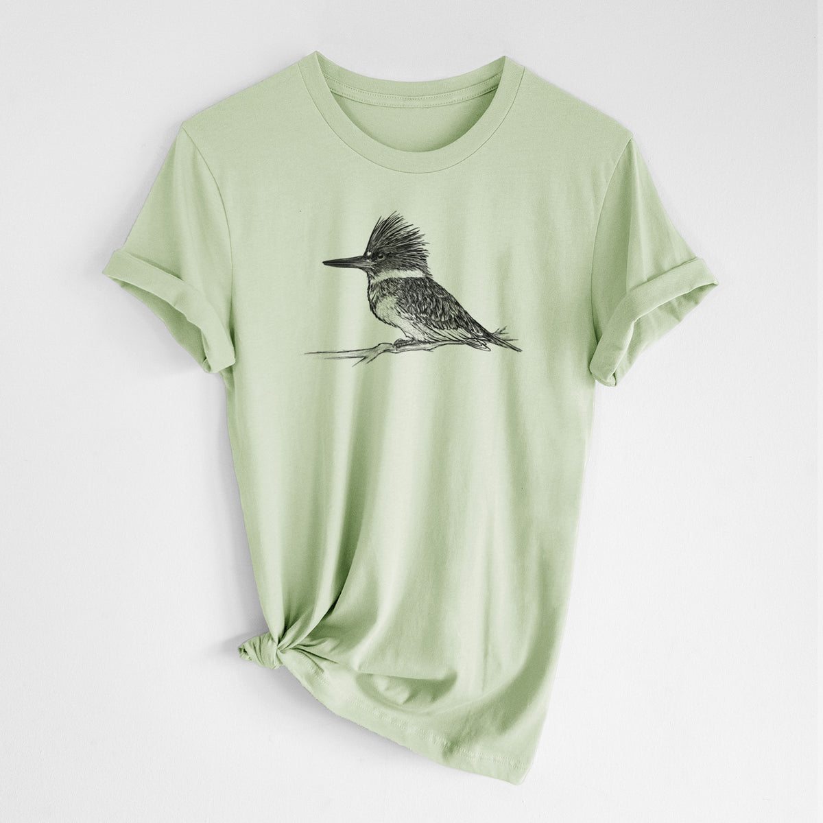 Spring green lightweight cotton t-shirt laid flat with the sleeves rolled, printed with a detailed black ink sketch of a belted kingfisher perched on a branch.