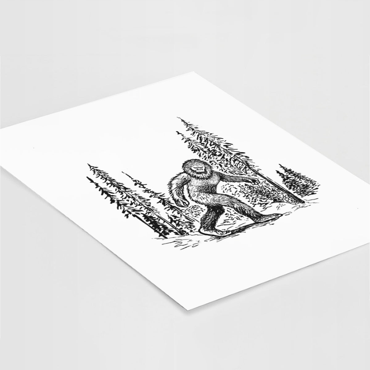 Art print of a black ink illustration of Bigfoot walking through a pine forest, lying at an angle on a white surface.