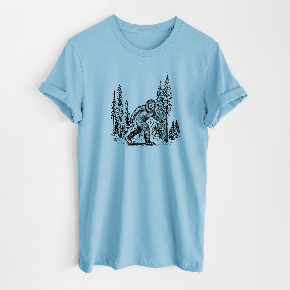 Ocean blue lightweight cotton t-shirt laid flat, printed with a black ink illustration of Bigfoot walking through a pine forest.