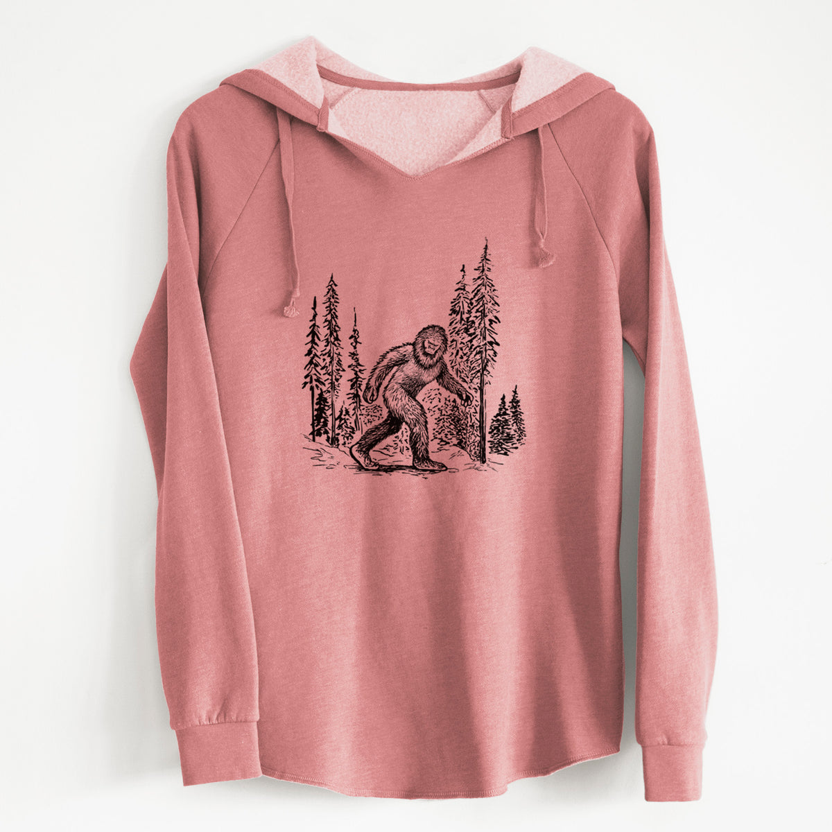 Dusty rose women's Cali Wave hooded sweatshirt laid flat, printed with a black ink illustration of Bigfoot walking through a pine forest.