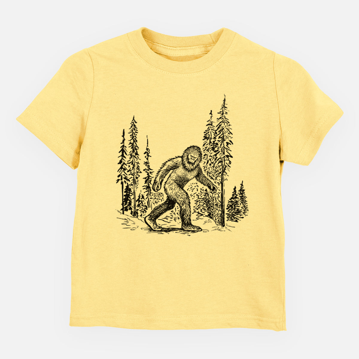 Butter yellow toddler t-shirt laid flat, printed with a black ink illustration of Bigfoot walking through a pine forest.