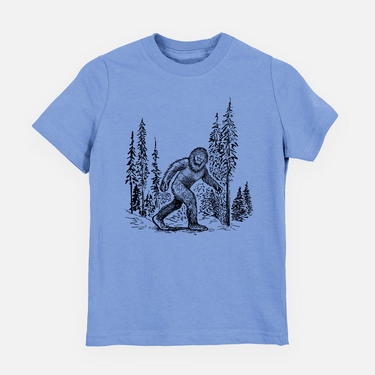 Carolina blue youth t-shirt laid flat, printed with a black ink illustration of Bigfoot walking through a pine forest.