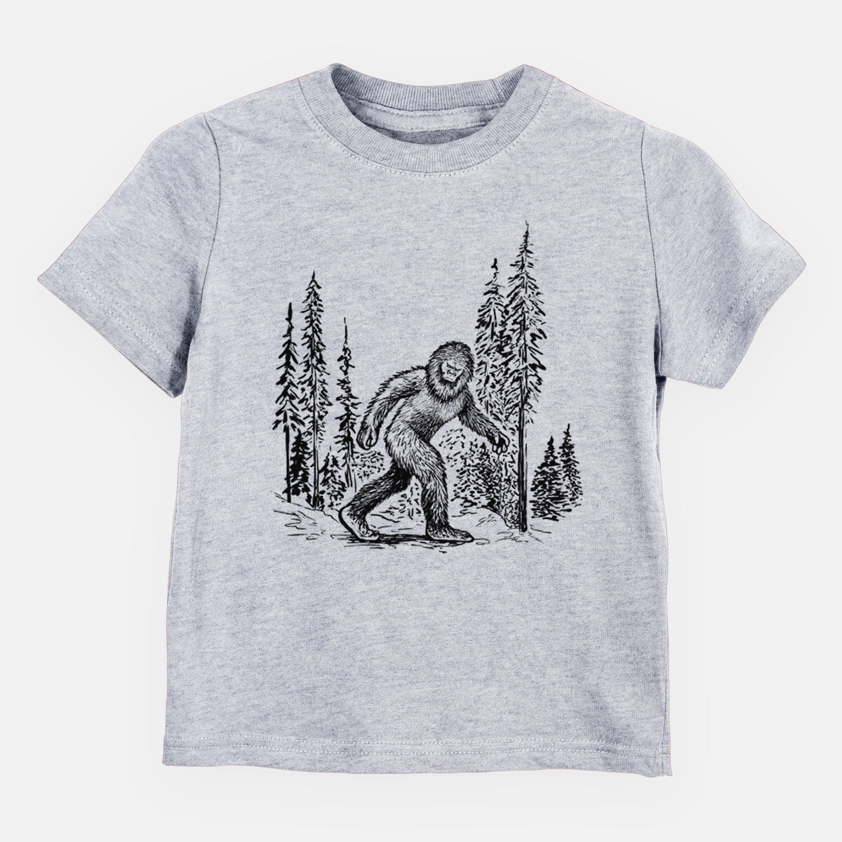 Heather grey toddler t-shirt laid flat, printed with a black ink illustration of Bigfoot walking through a pine forest.