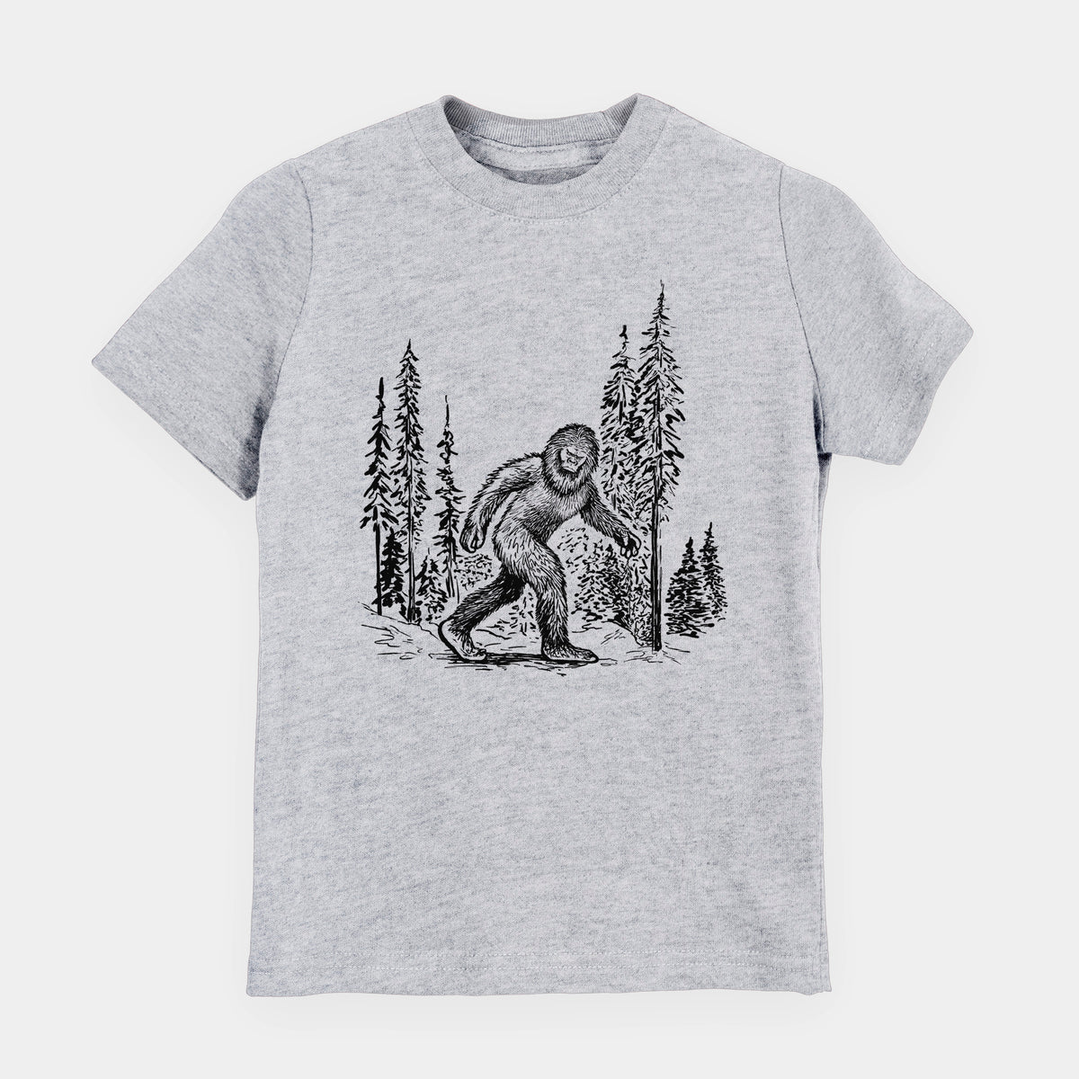 Heather grey youth t-shirt laid flat, printed with a black ink illustration of Bigfoot walking through a pine forest.