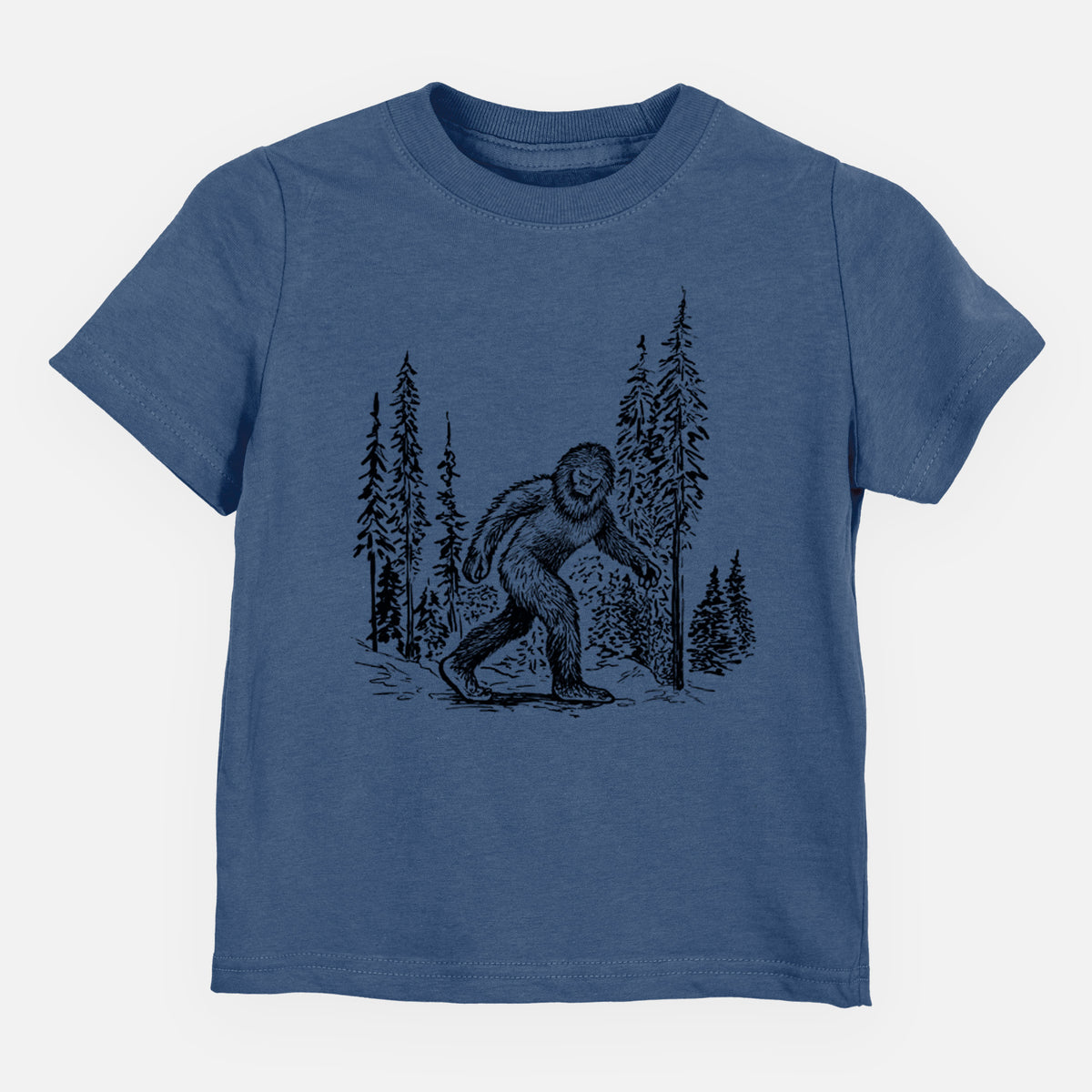 Indigo blue toddler t-shirt laid flat, printed with a black ink illustration of Bigfoot walking through a pine forest.