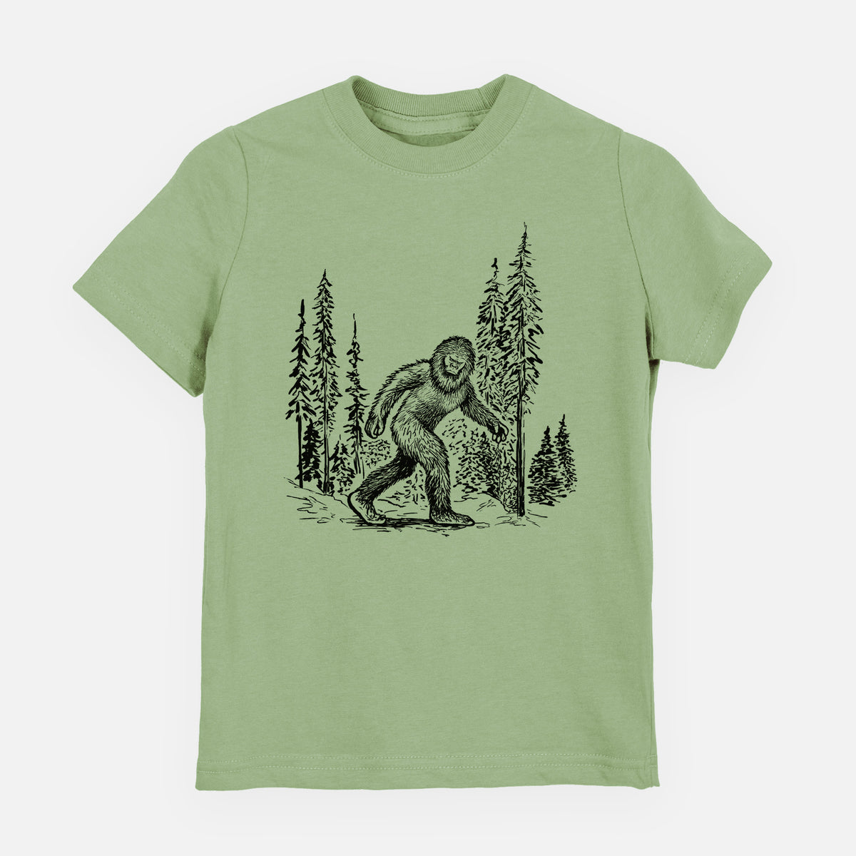 Sage green youth t-shirt laid flat, printed with a black ink illustration of Bigfoot walking through a pine forest.