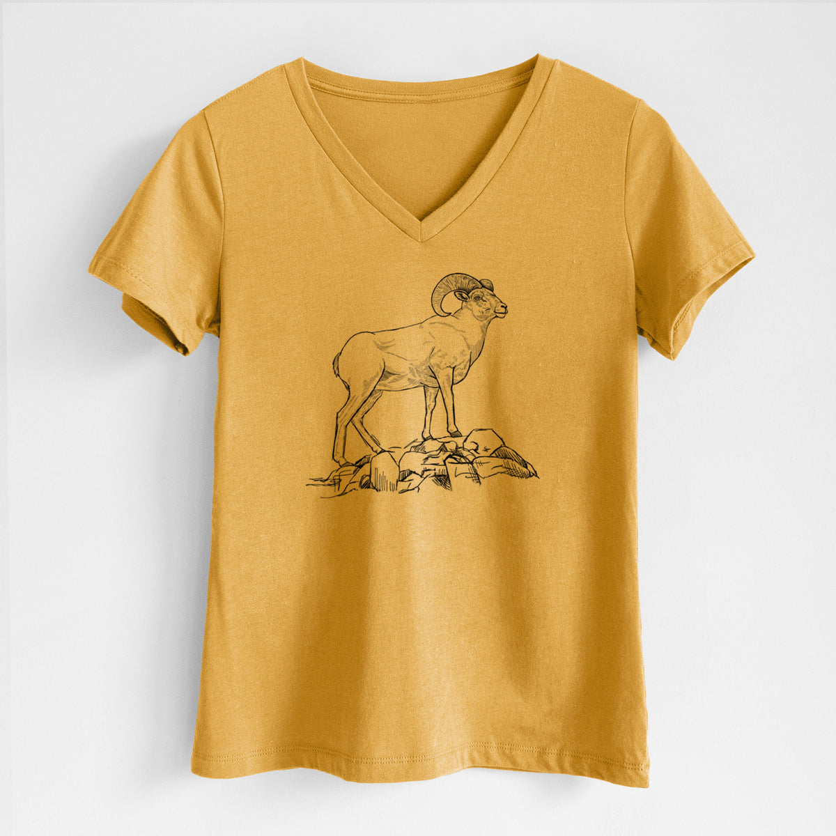 Honeycomb yellow women's relaxed fit cotton V-neck t-shirt laid flat, printed with a black ink illustration of a bighorn ram with curled horns standing on rocks.