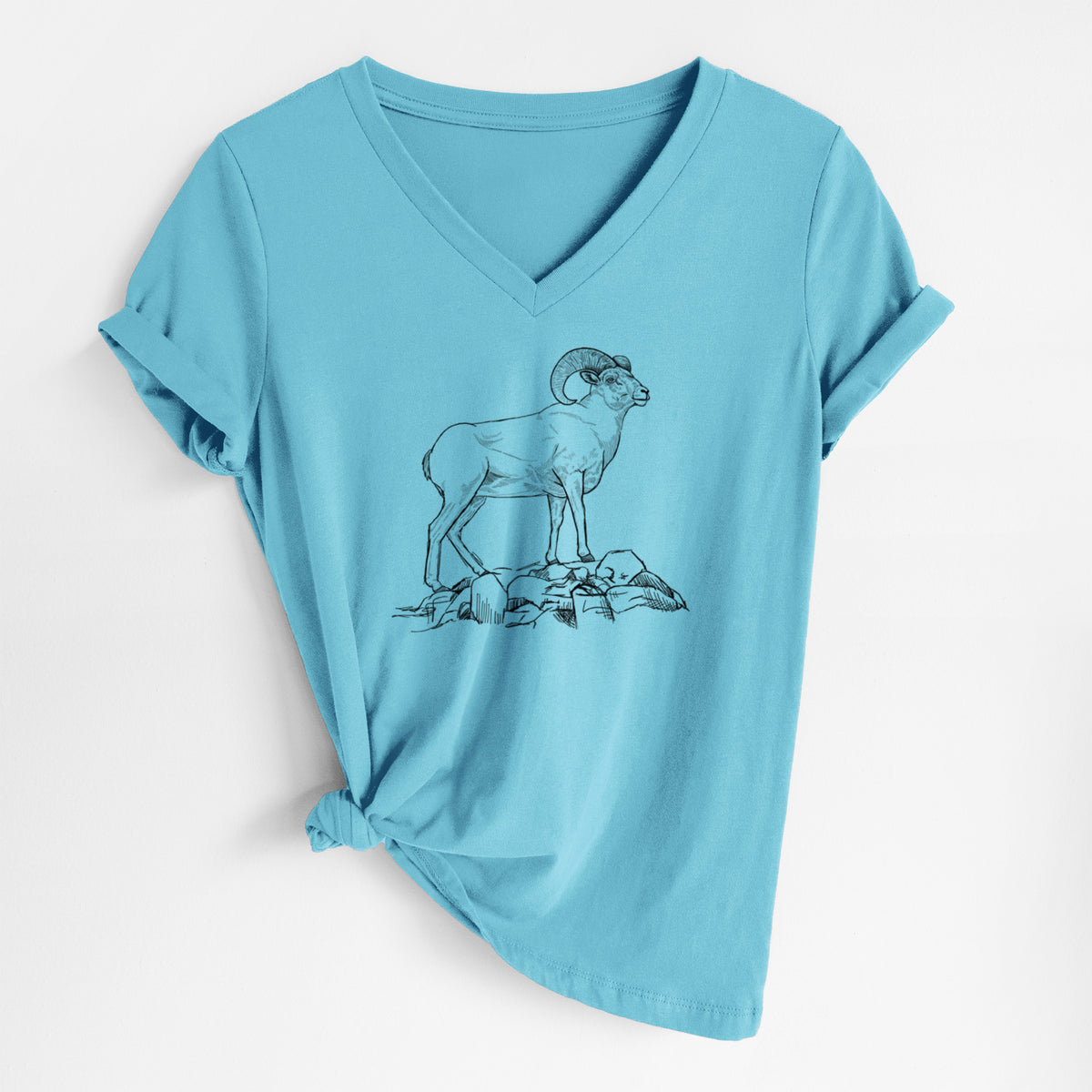 Turquoise women's relaxed fit cotton V-neck t-shirt laid flat, printed with a black ink illustration of a bighorn ram with curled horns standing on rocks.