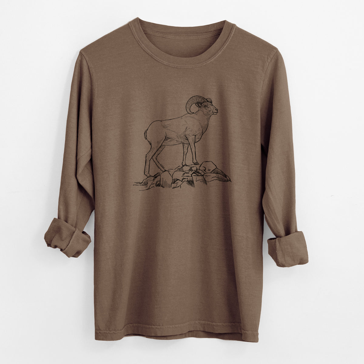 Espresso brown Comfort Colors long sleeve shirt laid flat with the cuffs rolled, printed with a black ink illustration of a bighorn ram with curled horns standing on rocks.