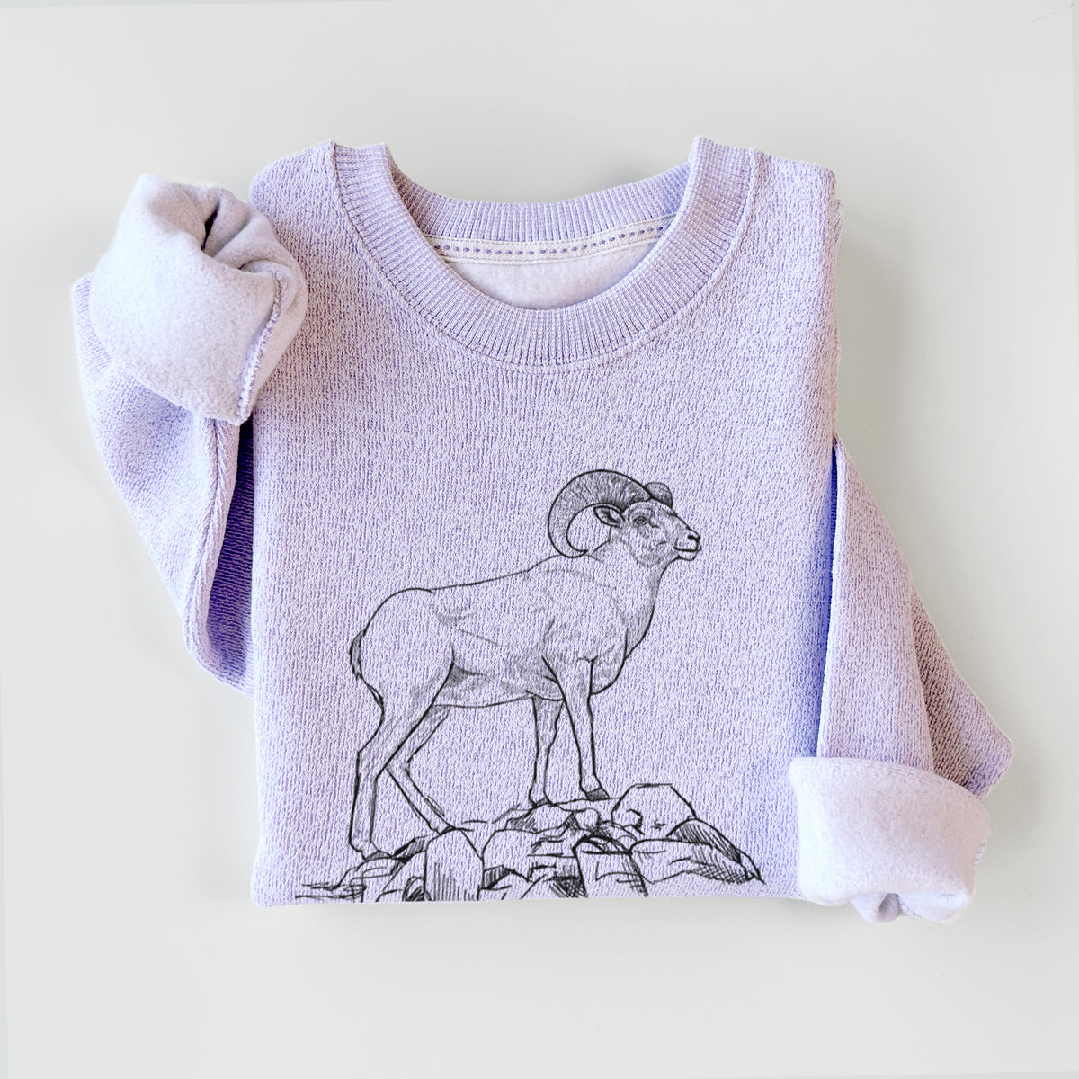 Ice purple knit sweatshirt printed with a black ink illustration of a bighorn ram with curled horns standing on rocks, styled flat.