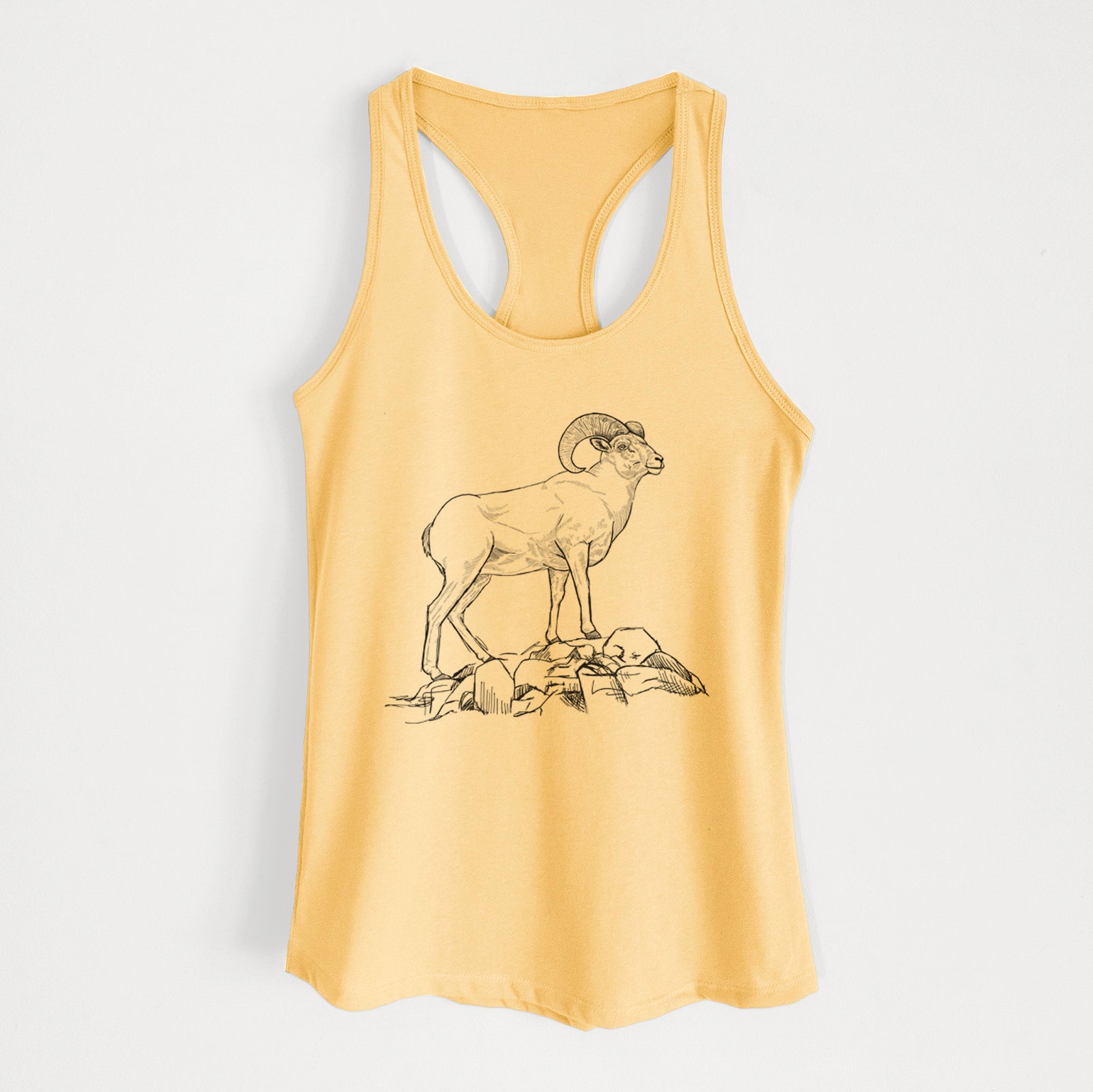 Banana cream women's racerback tank top laid flat, printed with a black ink illustration of a bighorn ram with curled horns standing on rocks.