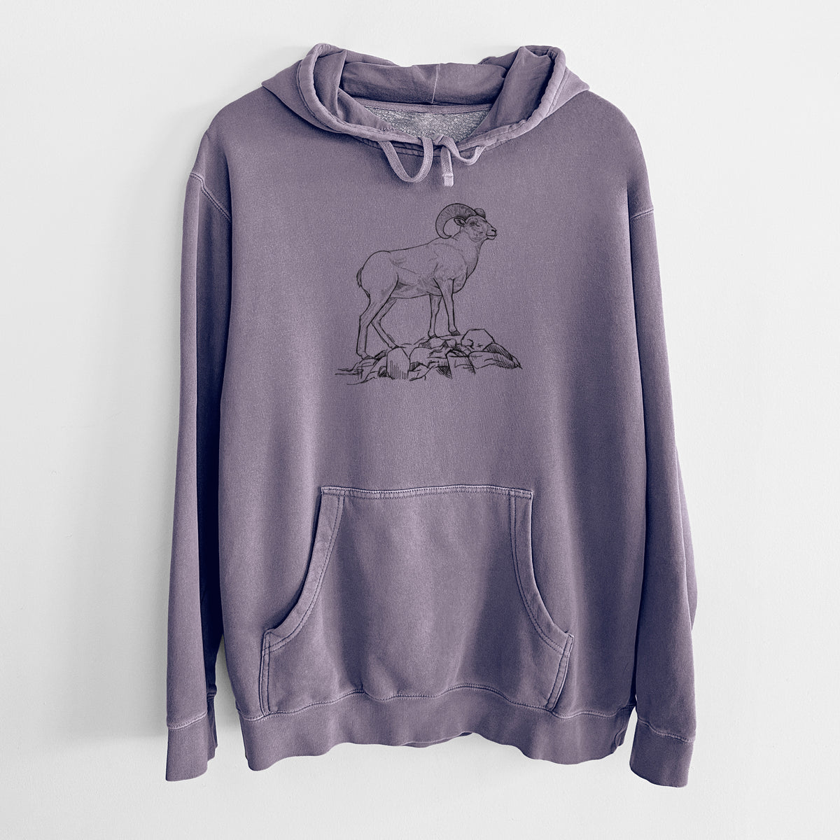 Plum purple pigment dyed hoodie laid flat, printed with a black ink illustration of a bighorn ram with curled horns standing on rocks.