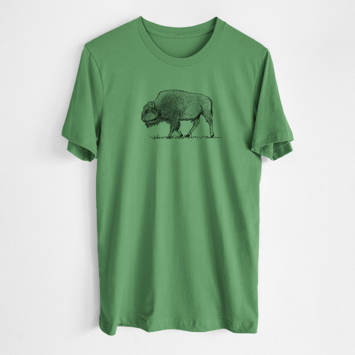 Leaf green lightweight cotton t-shirt laid flat, printed with a detailed black ink illustration of an American bison walking through grass.