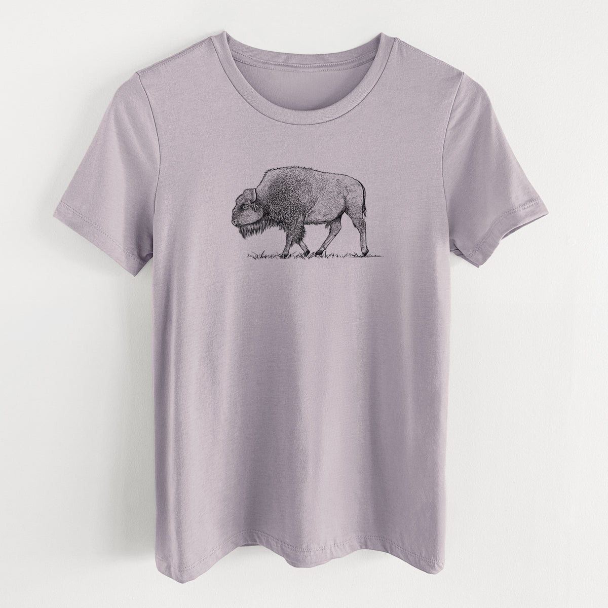 Light violet women's relaxed fit cotton t-shirt laid flat, printed with a detailed black ink illustration of an American bison walking through grass.