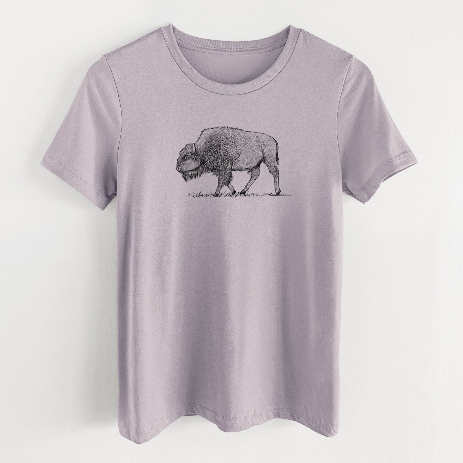 Light violet women's relaxed fit cotton t-shirt laid flat, printed with a detailed black ink illustration of an American bison walking through grass.