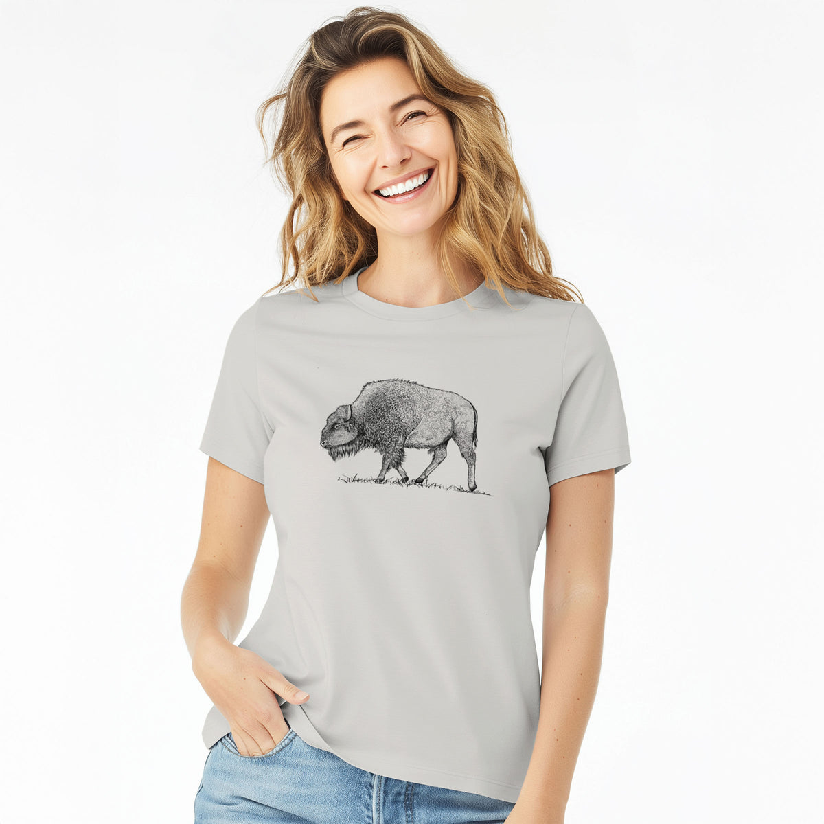 Woman wearing a lunar grey women's relaxed fit cotton t-shirt printed with a detailed black ink illustration of an American bison walking through grass.