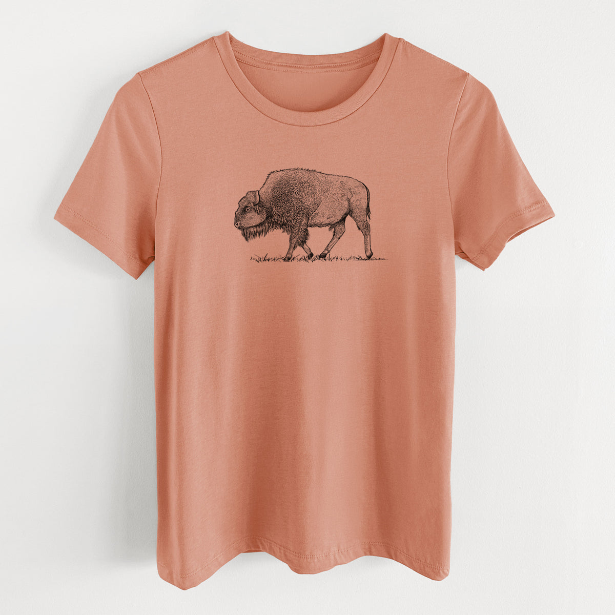 Terracotta orange women's relaxed fit cotton t-shirt laid flat, printed with a detailed black ink illustration of an American bison walking through grass.