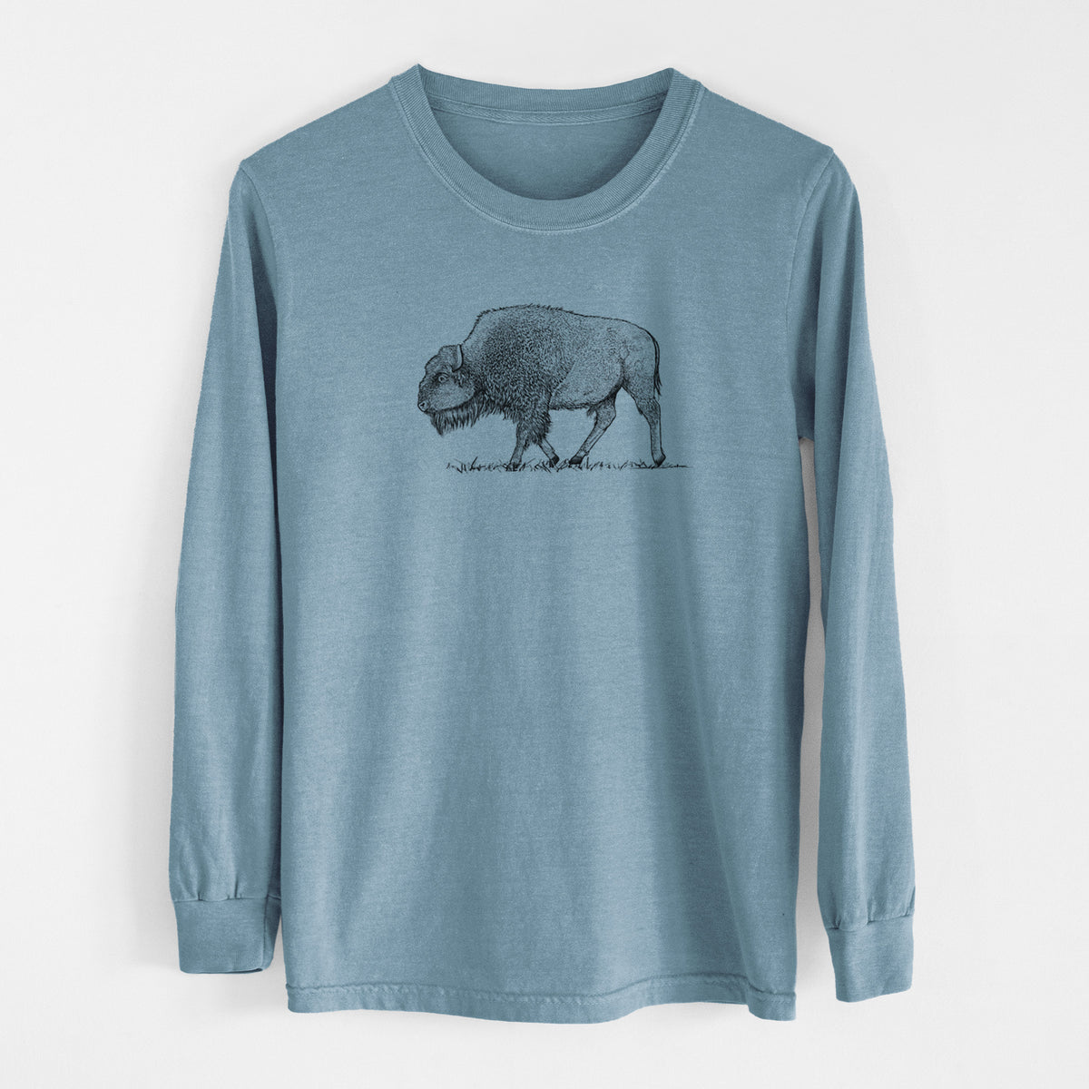 Steel blue Comfort Colors long sleeve shirt laid flat, printed with a detailed black ink illustration of an American bison walking through grass.