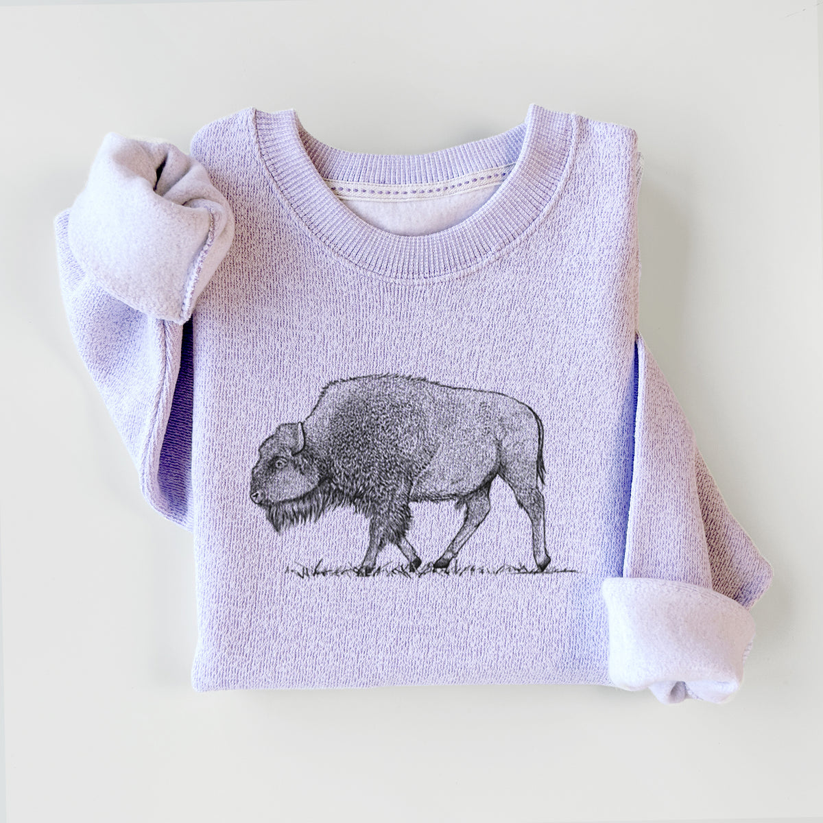Ice purple knit sweatshirt printed with a detailed black ink illustration of an American bison walking through grass, styled flat.