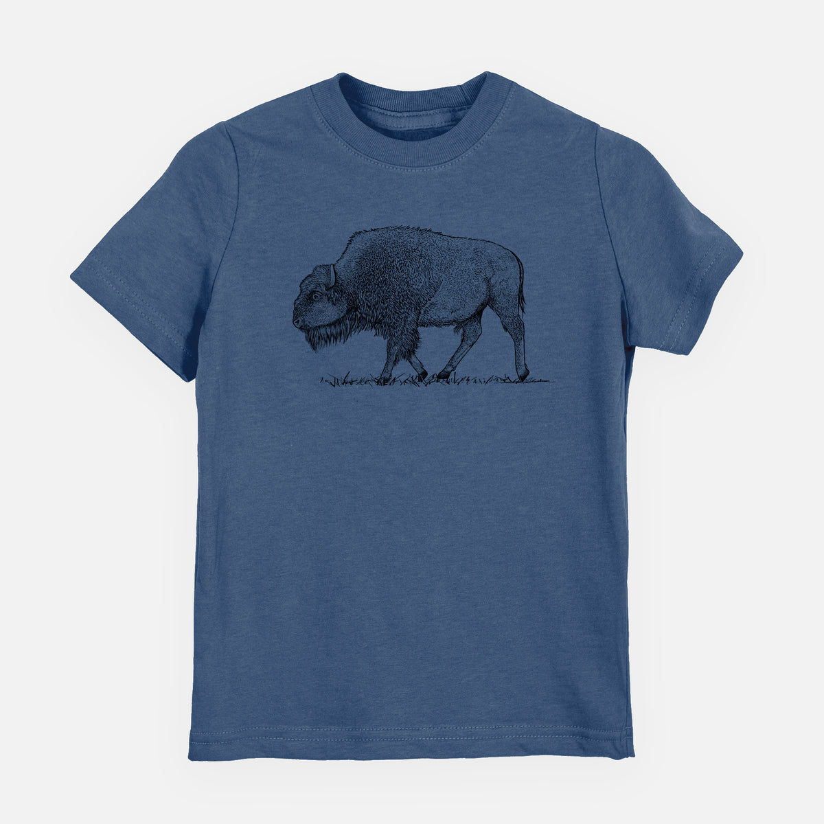 Indigo blue youth t-shirt laid flat, printed with a detailed black ink illustration of an American bison walking through grass.